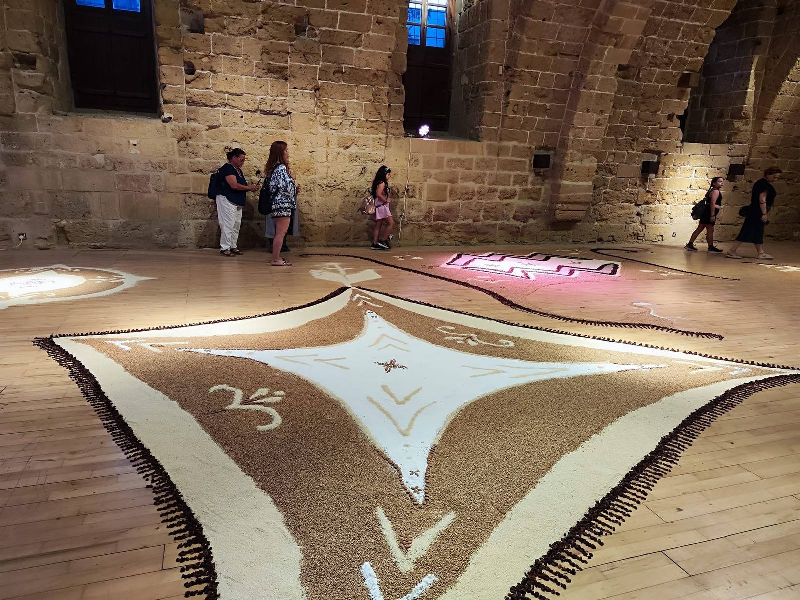 Eutopia textile installation across the wooden floor of Kastelliotissa Hall